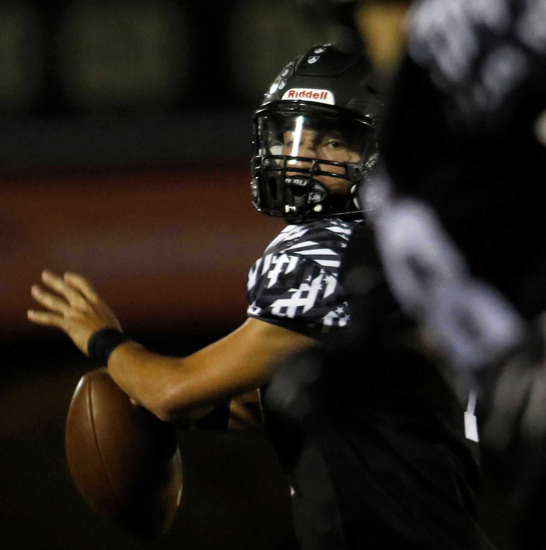 Bishop Lynch quarterback Michael Light (1) prepares to deliver a touchdown pass to receiver...