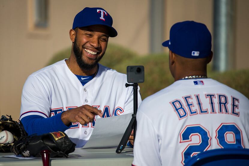Texas Rangers shortstop Elvis Andrus tells jokes to third baseman Adrian Beltre as part of a...