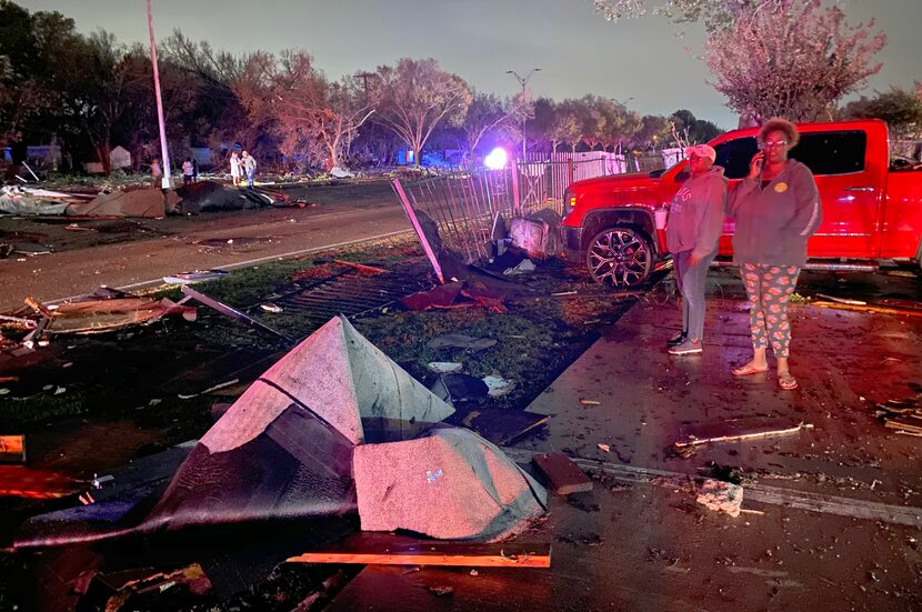 High winds scattered debris from an apartment complex along Pioneer Parkway between Center...