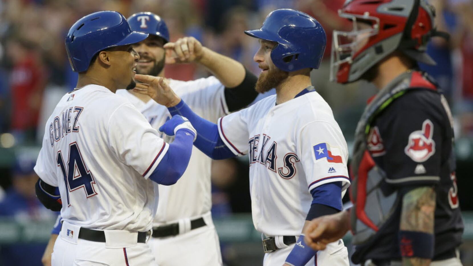 Texas Rangers' Carlos Gomez (14) celebrates his three run homer at home plate with teammates...