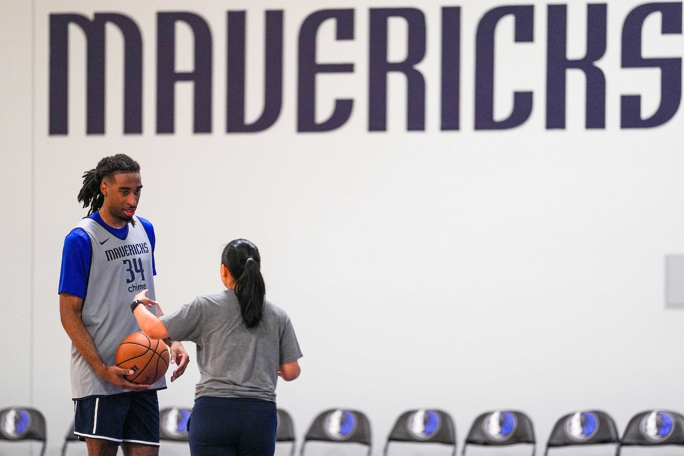 Dallas Mavericks forward Isaiah Whaley (34) works with assistant coach Shannan Lum during a...