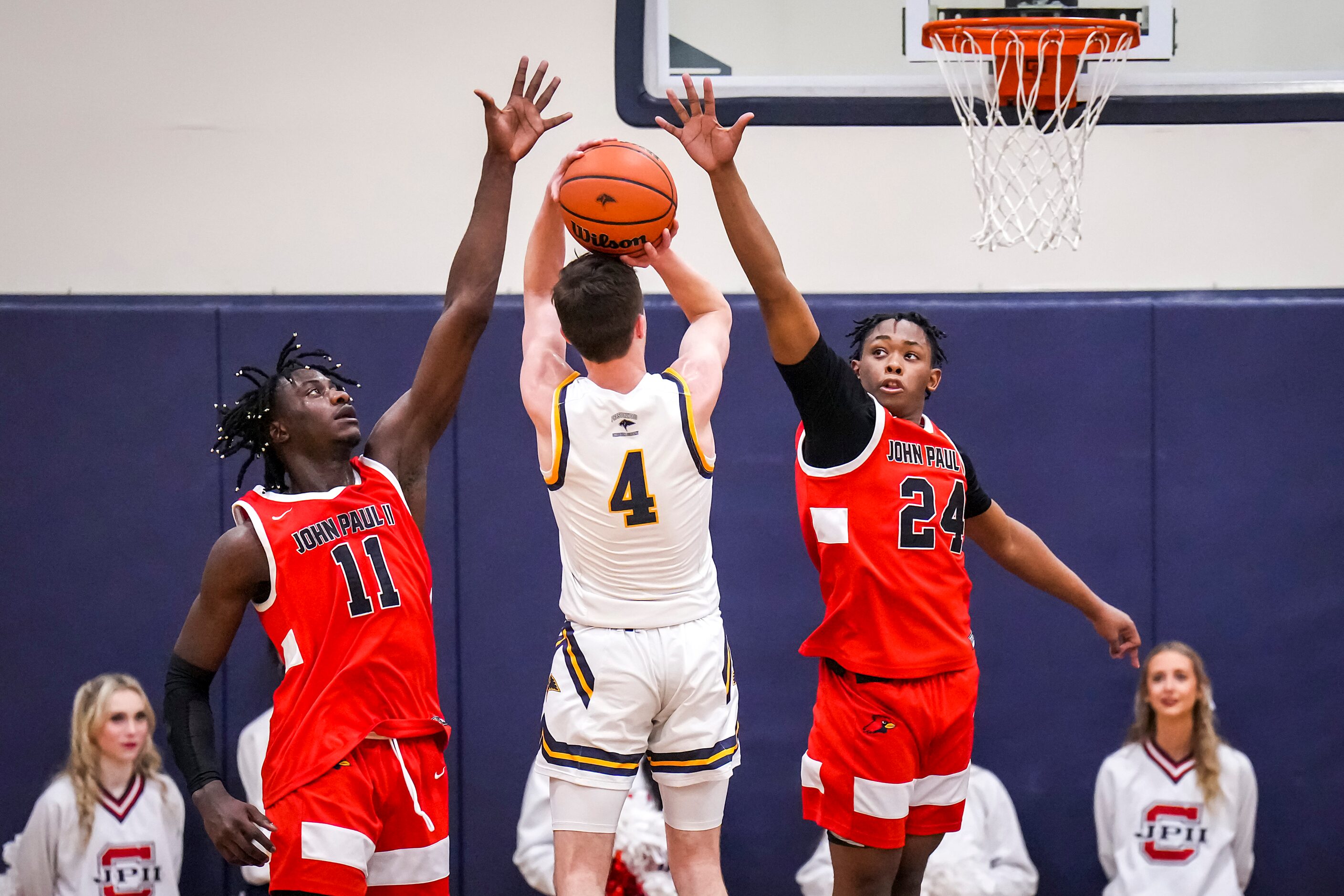 Prestonwood Christian's Vincent Sigona  (4) shoots as John Paul II's Elijah Obaseki (11) and...