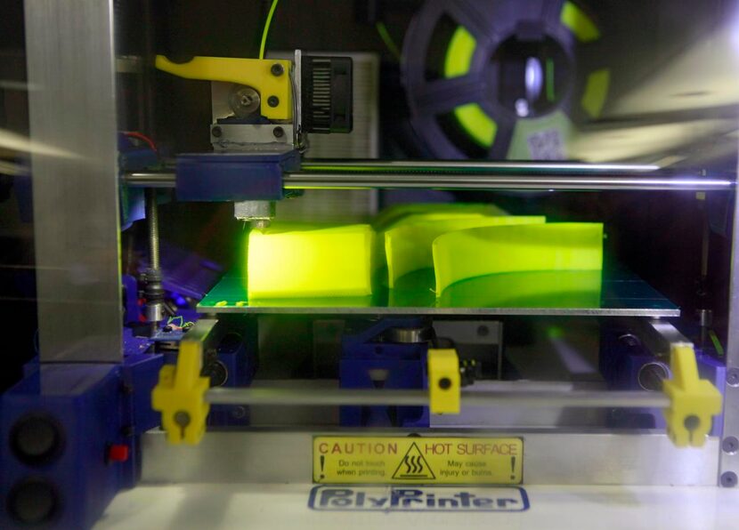 
The PolyPrinter 3-D printer works a print job from a user who sent the job from home on the...