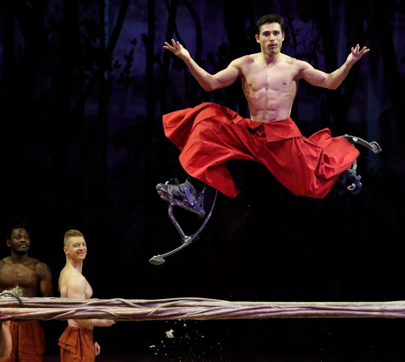 A performer on stilts jumps over a log during a preview of Cavalia's production Odysseo in...