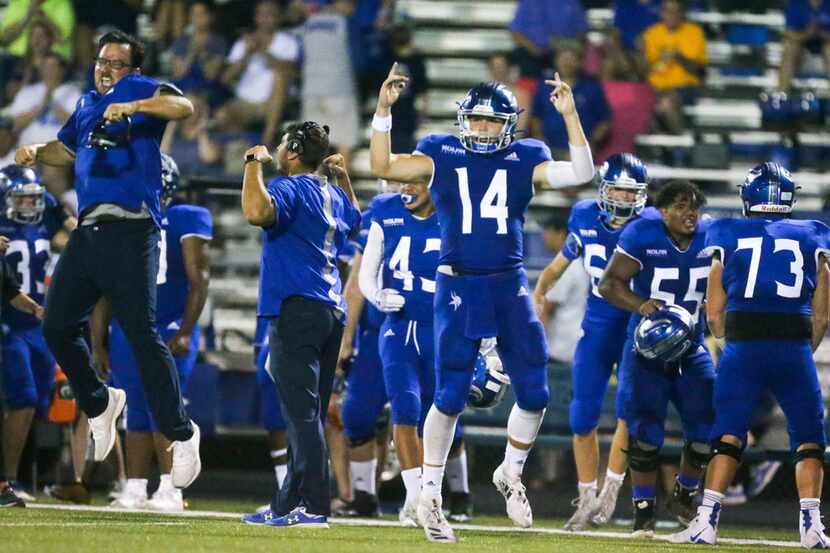 Nolan Catholic quarterback Jummy Taylor (14) celebrates after his team stopped Celina on a...