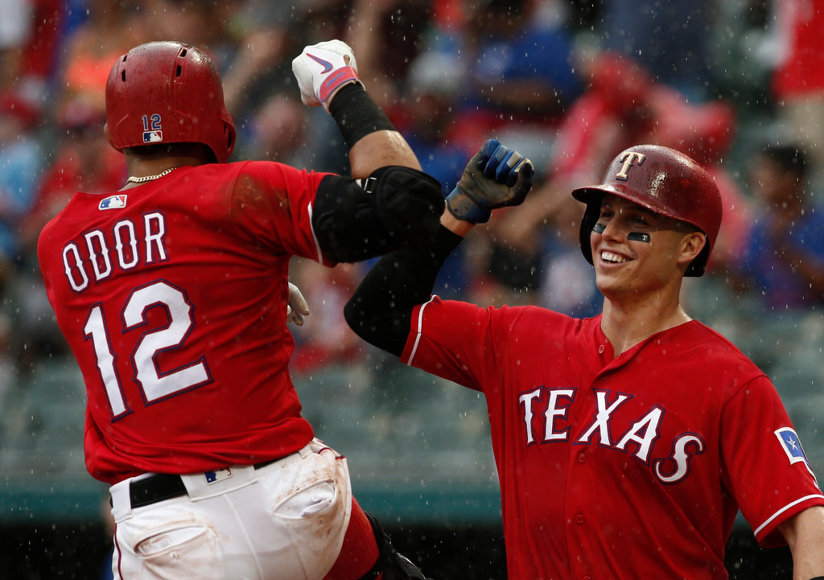 Texas Rangers' Rougned Odor is congratulated by Drew Robinson after he hit a three-run home...