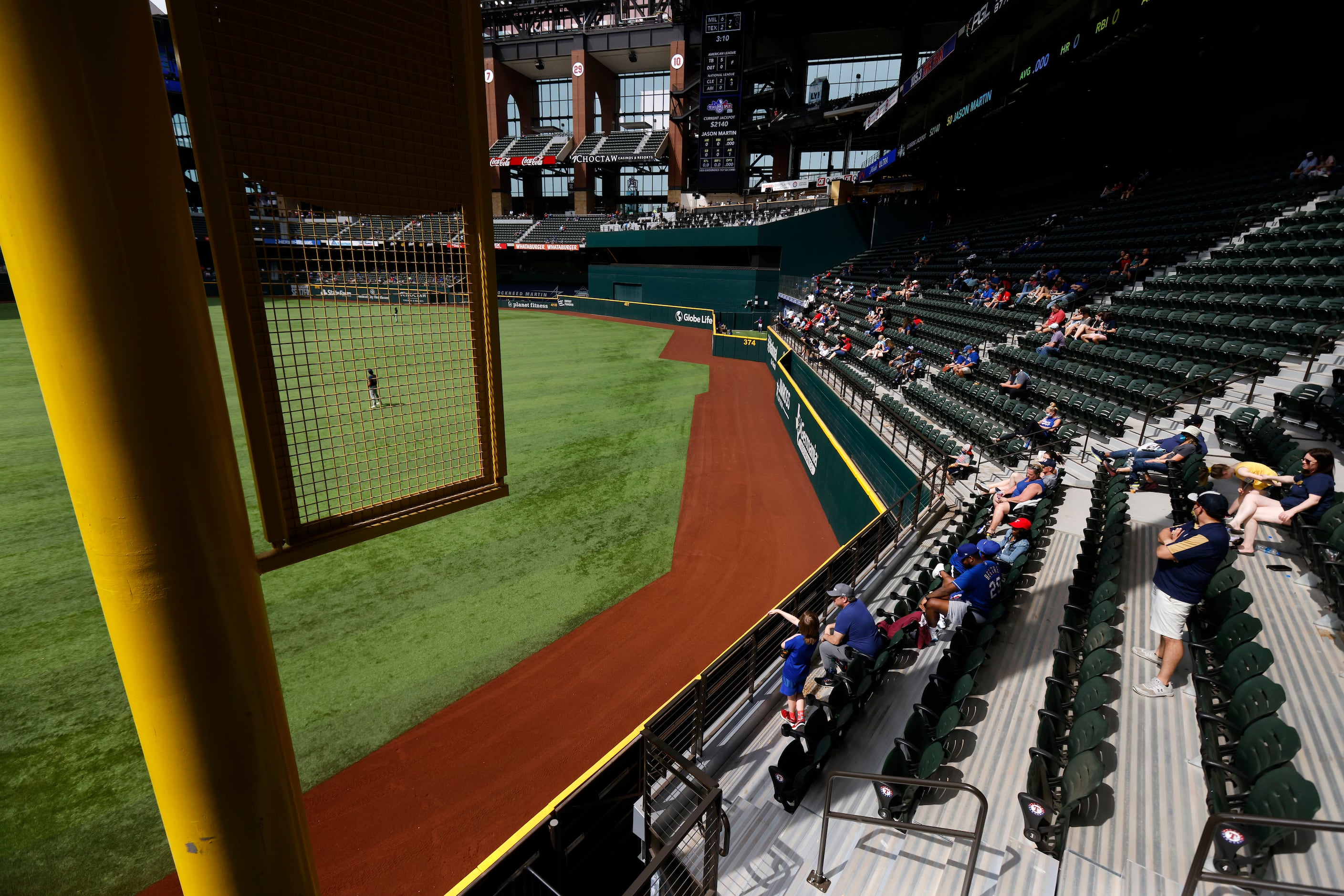 Texas Rangers fans in right field take in an afternoon exhibition baseball game at Globe...