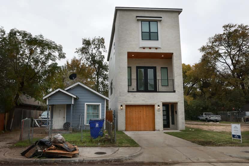 A shotgun house still stands next to a newly built home on Wednesday, Nov. 23, 2022 in...