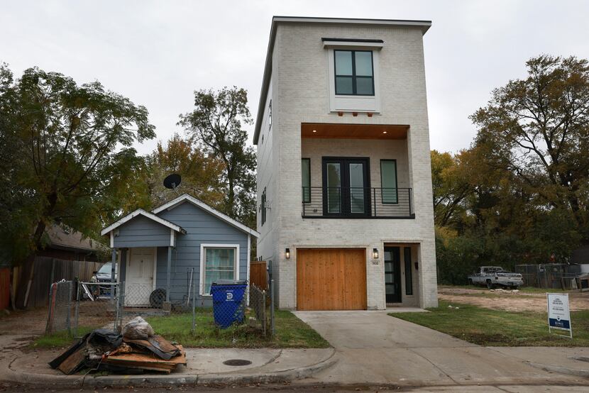 A shotgun house still stands next to a newly built home on Wednesday, Nov. 23, 2022 in...