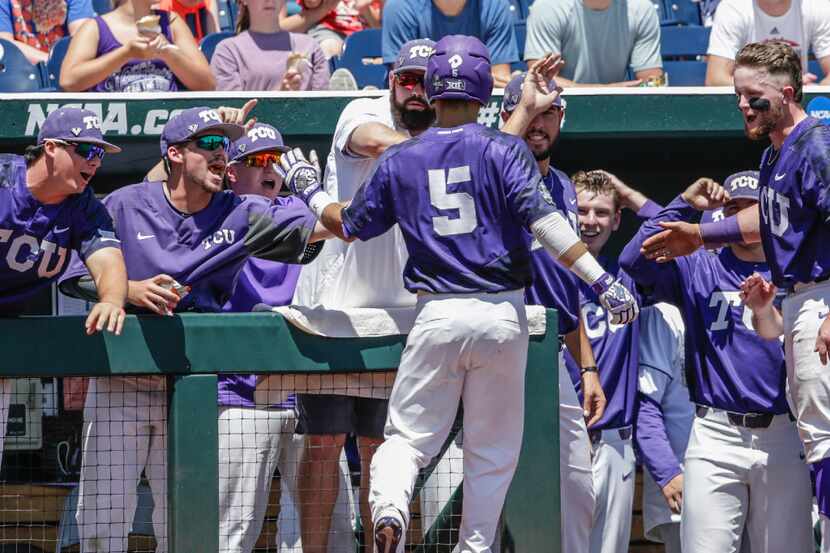 TCU shortstop Ryan Merrill (5) is greeted at the dugout after he scored a solo home run...