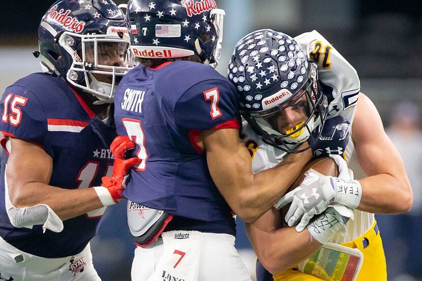 Highland Park wide receiver Finn Corwin (16) is wrapped up by Denton Ryan's Tra Smith (7)...