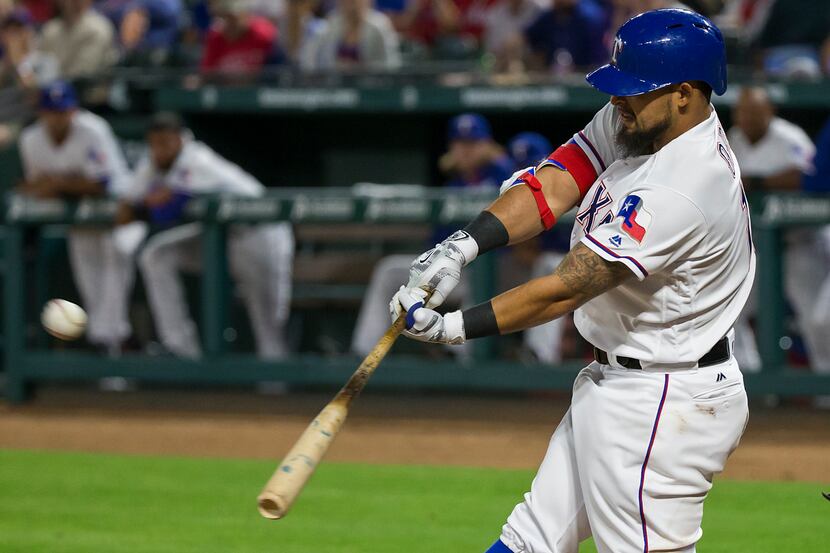 Texas Rangers second baseman Rougned Odor drives in two runs with a double in the sixth...