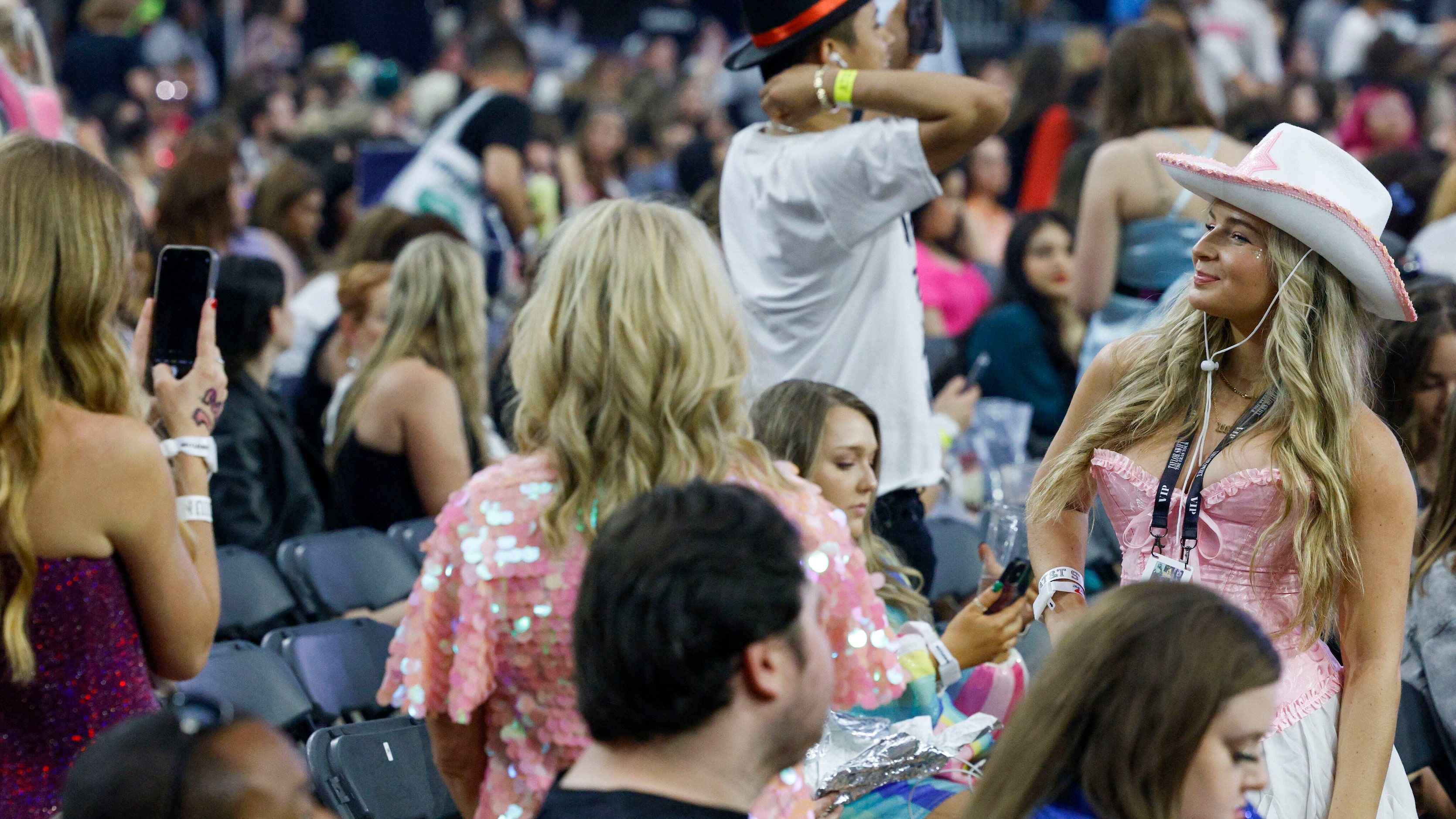 A fan poses for a photo before Taylor Swift takes the stage for the Eras Tour concert at...