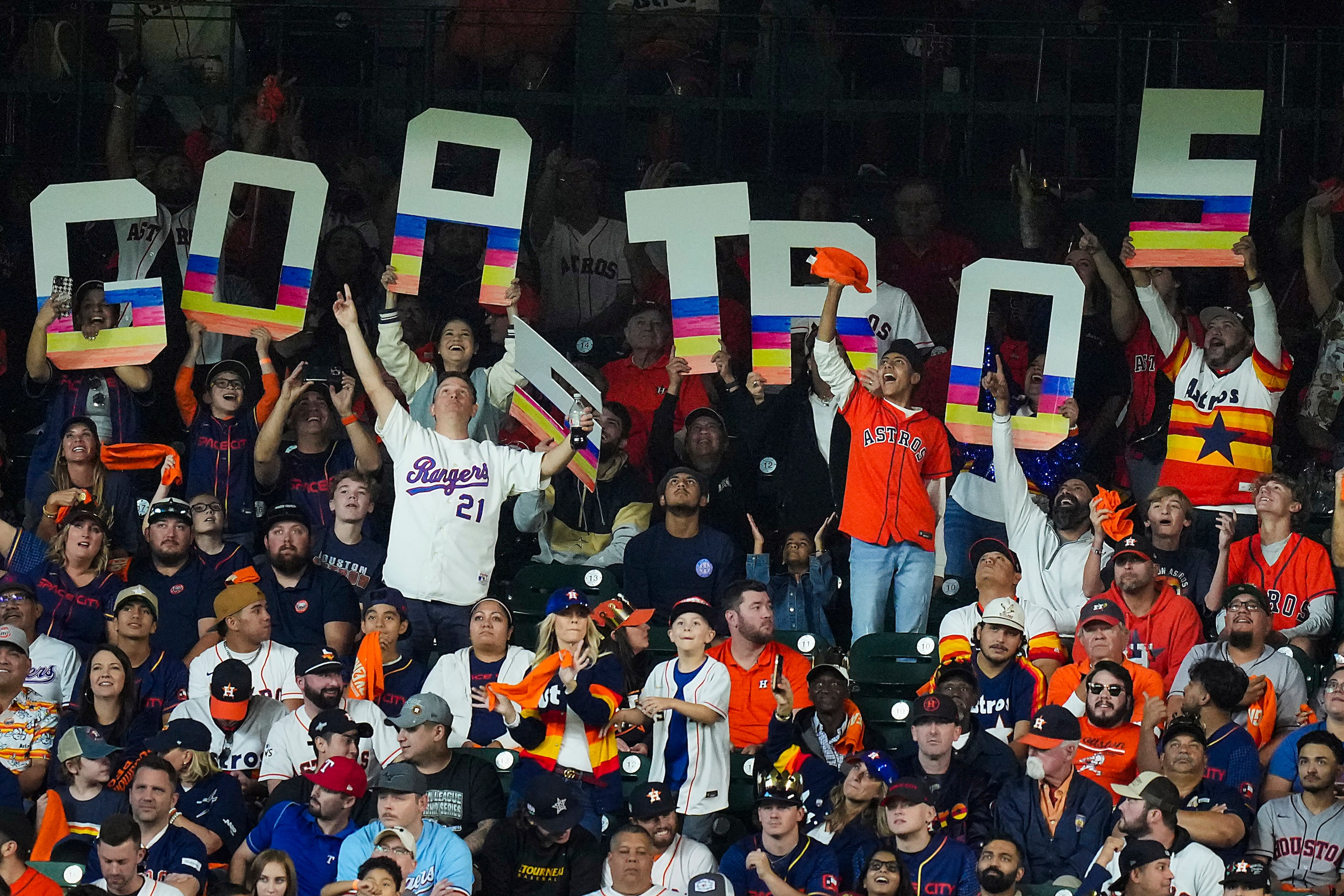 A Texas Rangers fan celebrates in a sea of Houston Astros fans during the fourth inning in...