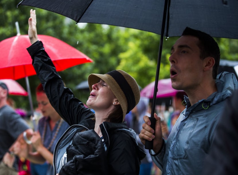 Amberand Mark Hapka sang Saturday at a service at Klyde Warren Park in downtown Dallas. The...