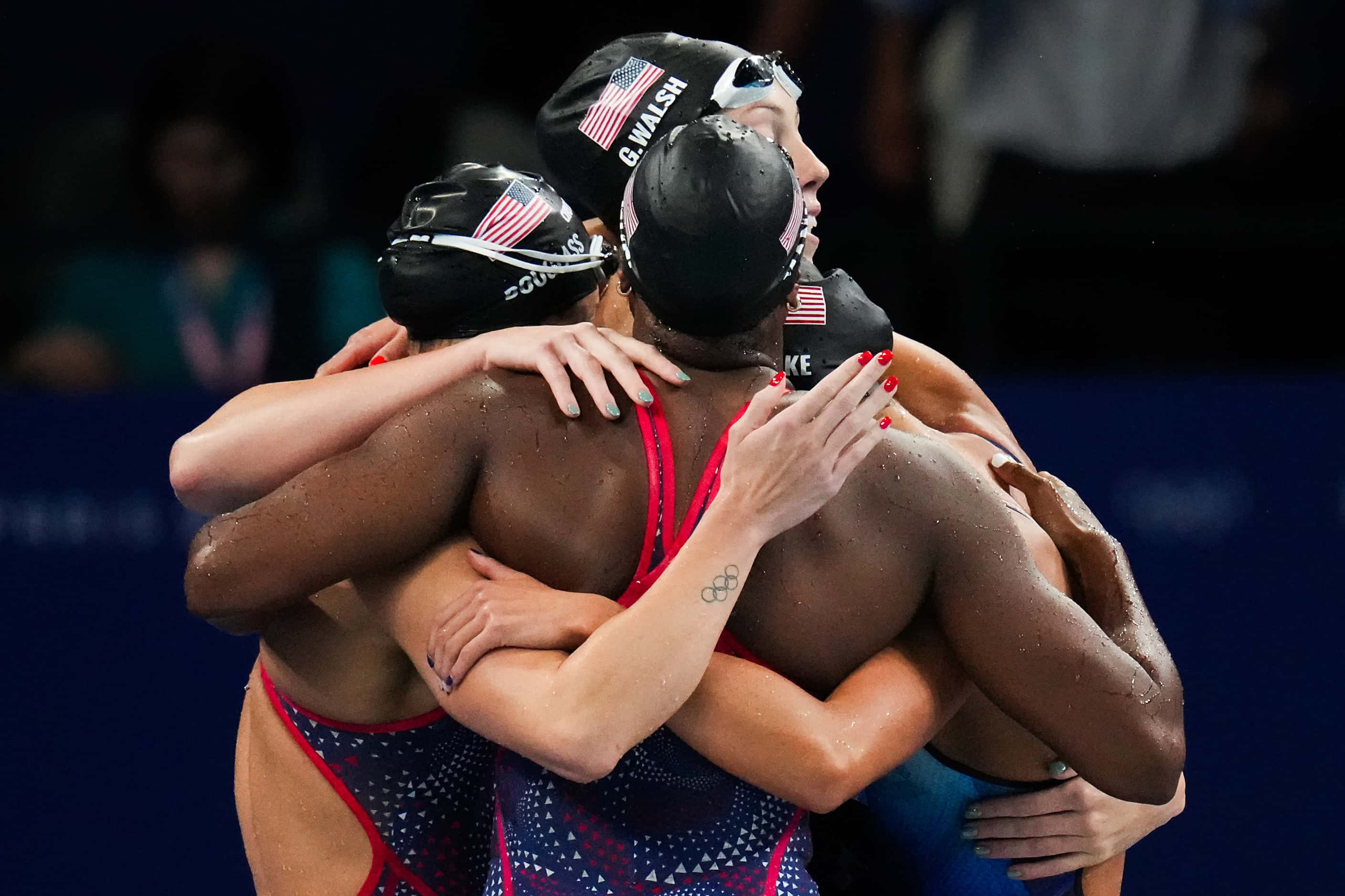 Members of the United States women's 4x100-meter freestyle relay team, from left, Kate...