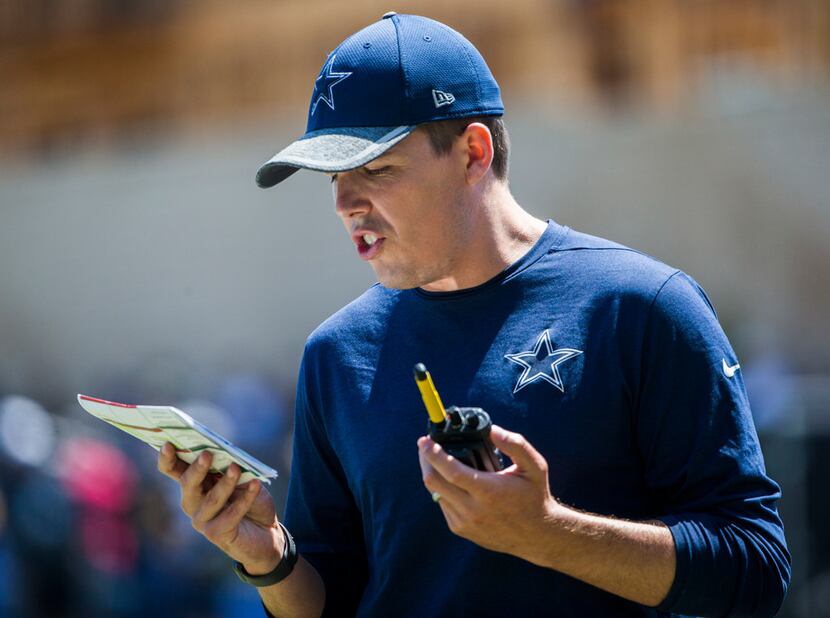Dallas Cowboys offensive coordinator Kellen Moore calls a play during a morning practice at...