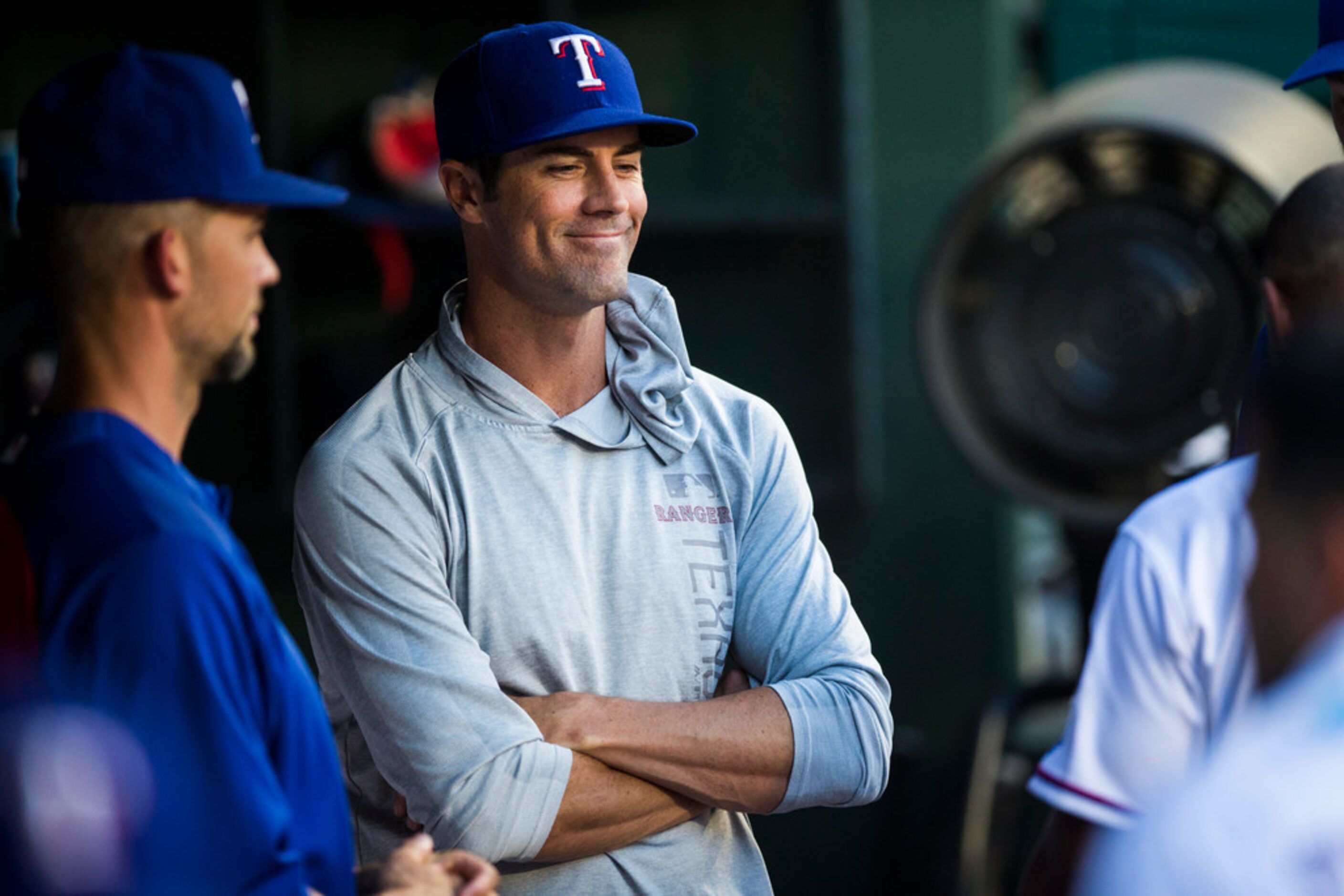 Texas Rangers starting pitcher Cole Hamels (35) smiles as he tells his team mates he's been...