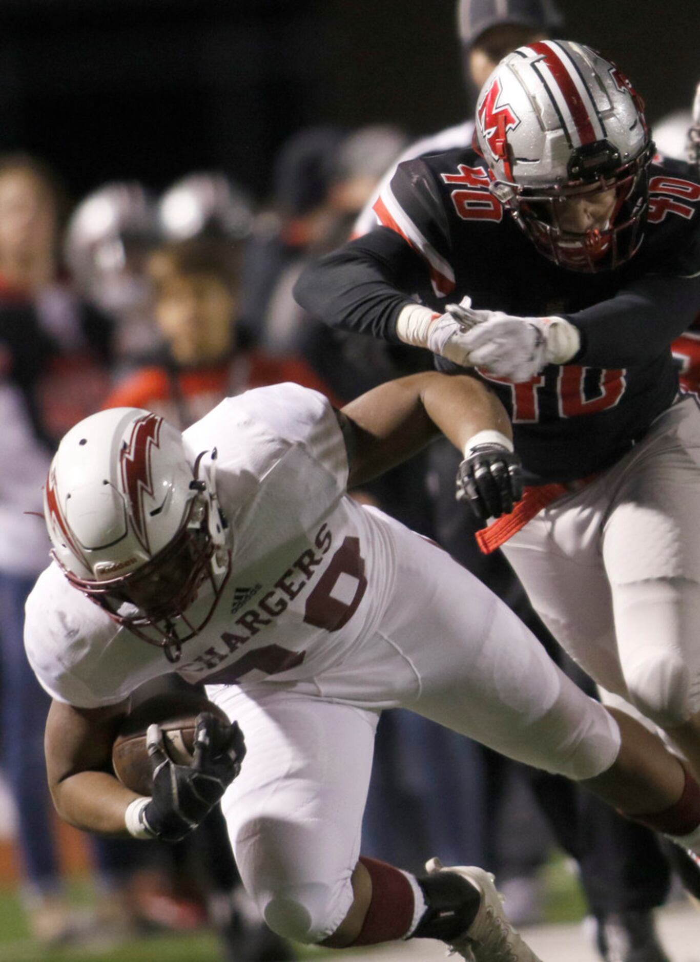 Keller Central running back Andrew Paul (30) takes a hit from Flower Mound Marcus defensive...