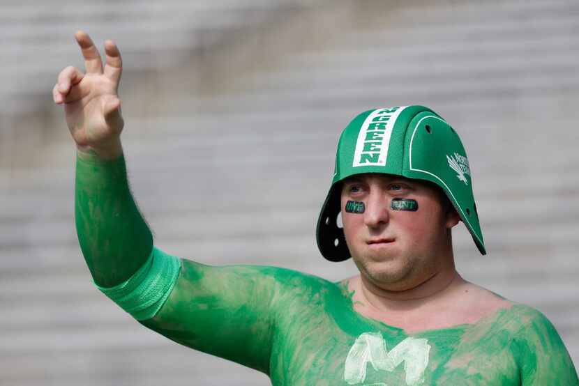 A North Texas fan cheers for his team, which took on Army during the Heart of Texas Bowl the...