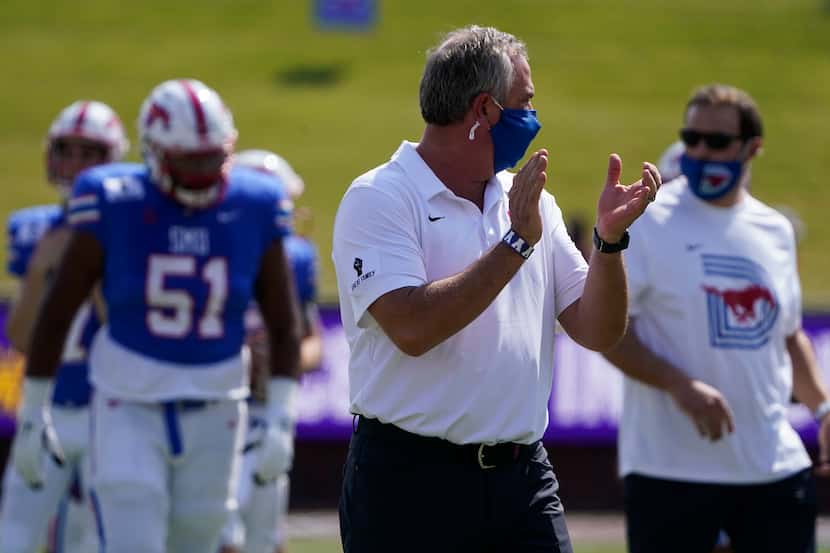 SMU head coach Sonny Dykes watches his team warm up before an NCAA football game against...