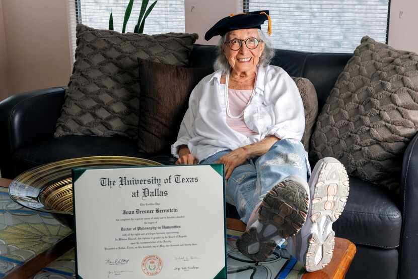Joan Bernstein, 88, wears her tam from her doctoral hooding ceremony alongside her doctor of...