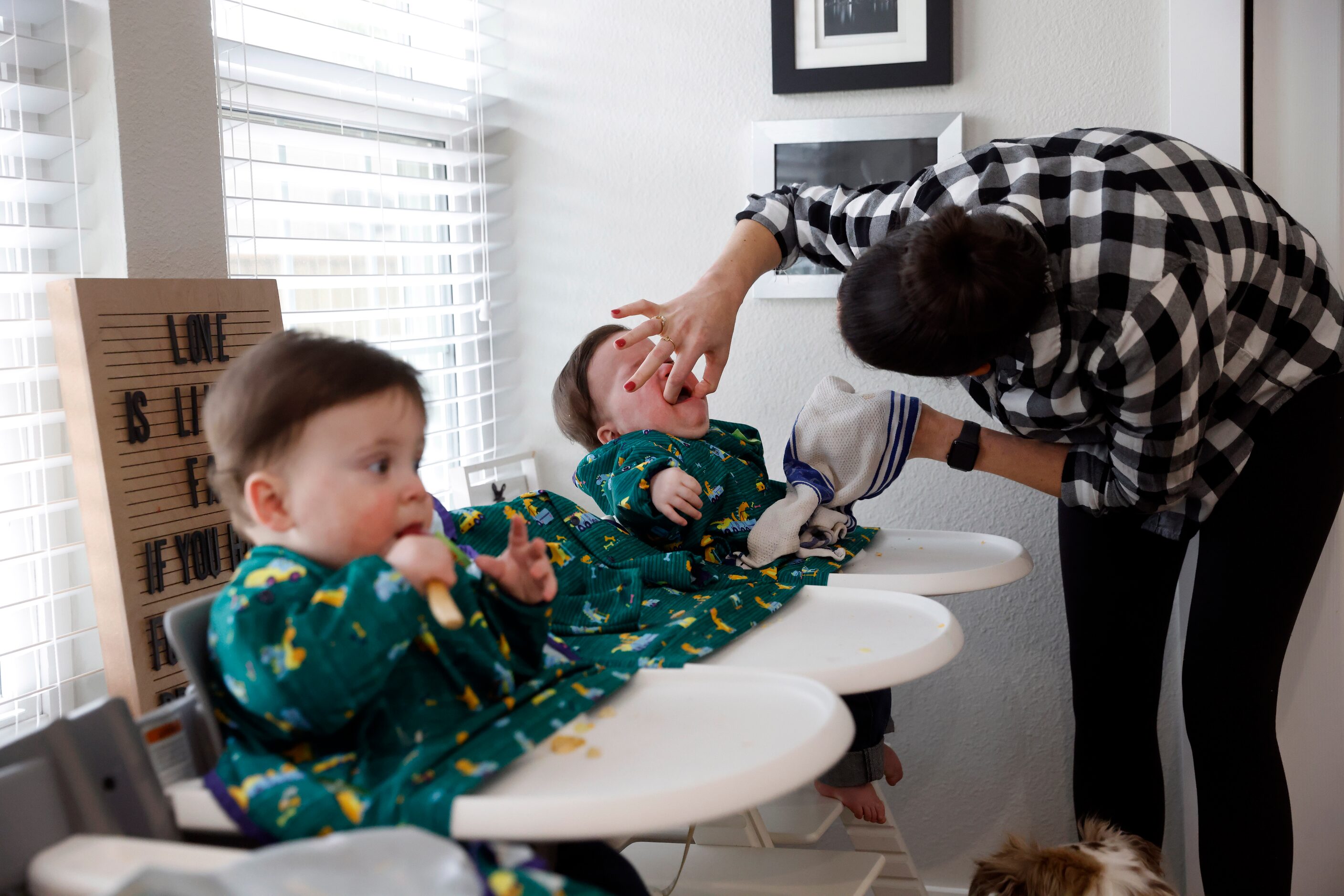 Jenny Marr checks for food in the mouth of Hudson Marr as Hardy works on eating a spoonful...