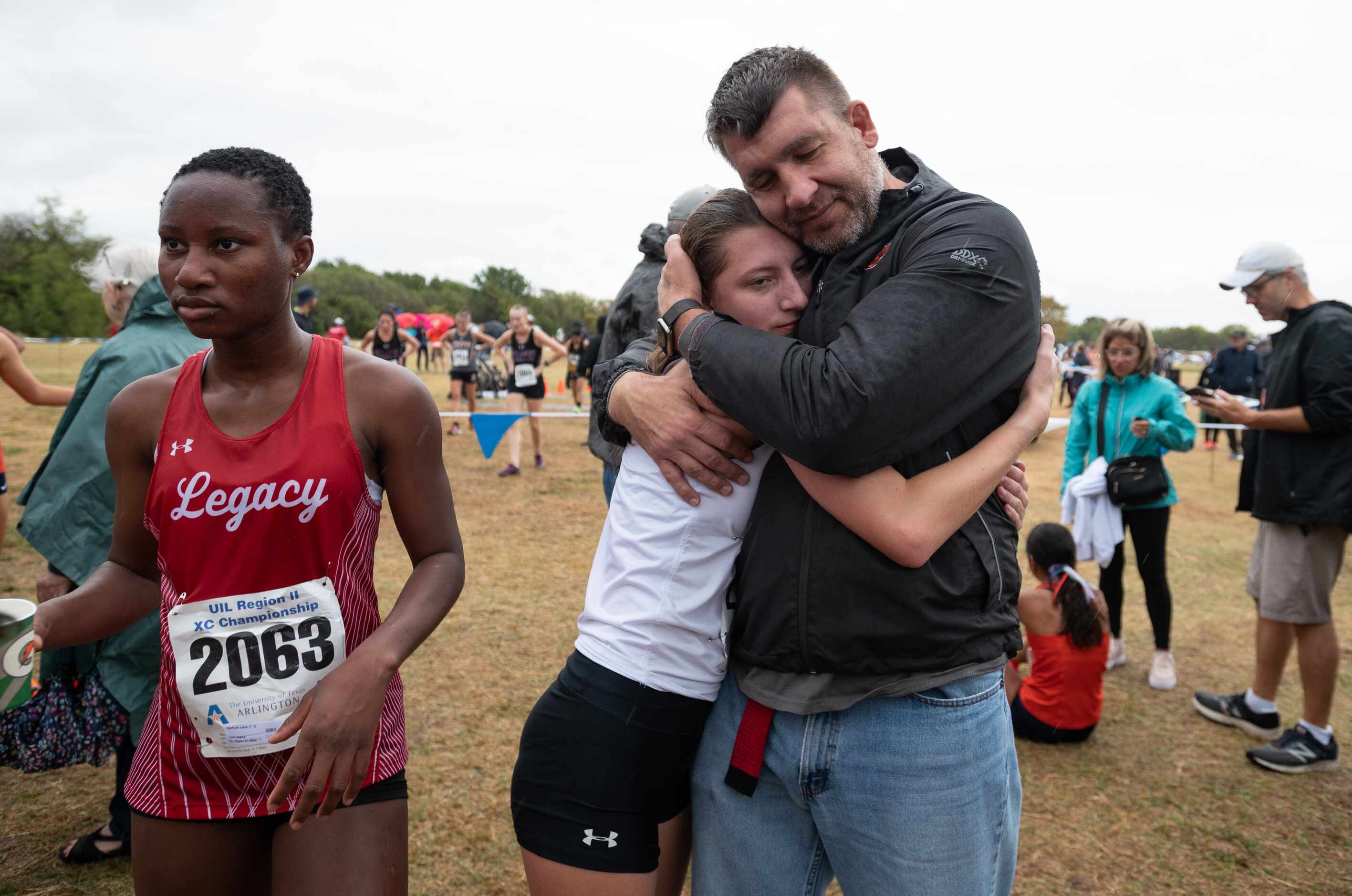 Klein Cain runner Erin McCowen is congratulated by her father John McCown after she ran in...