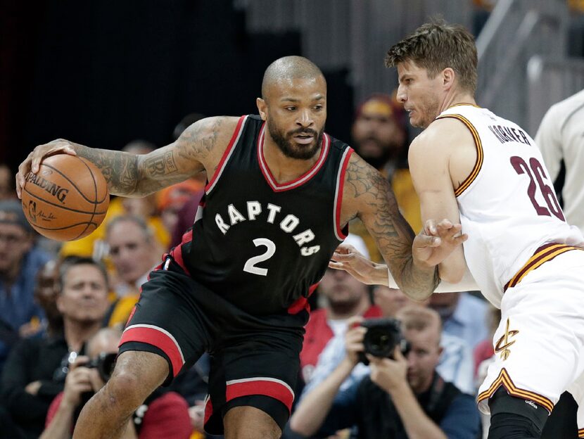 Toronto Raptors' P.J. Tucker (2) drives past Cleveland Cavaliers' Kyle Korver (26) in the...