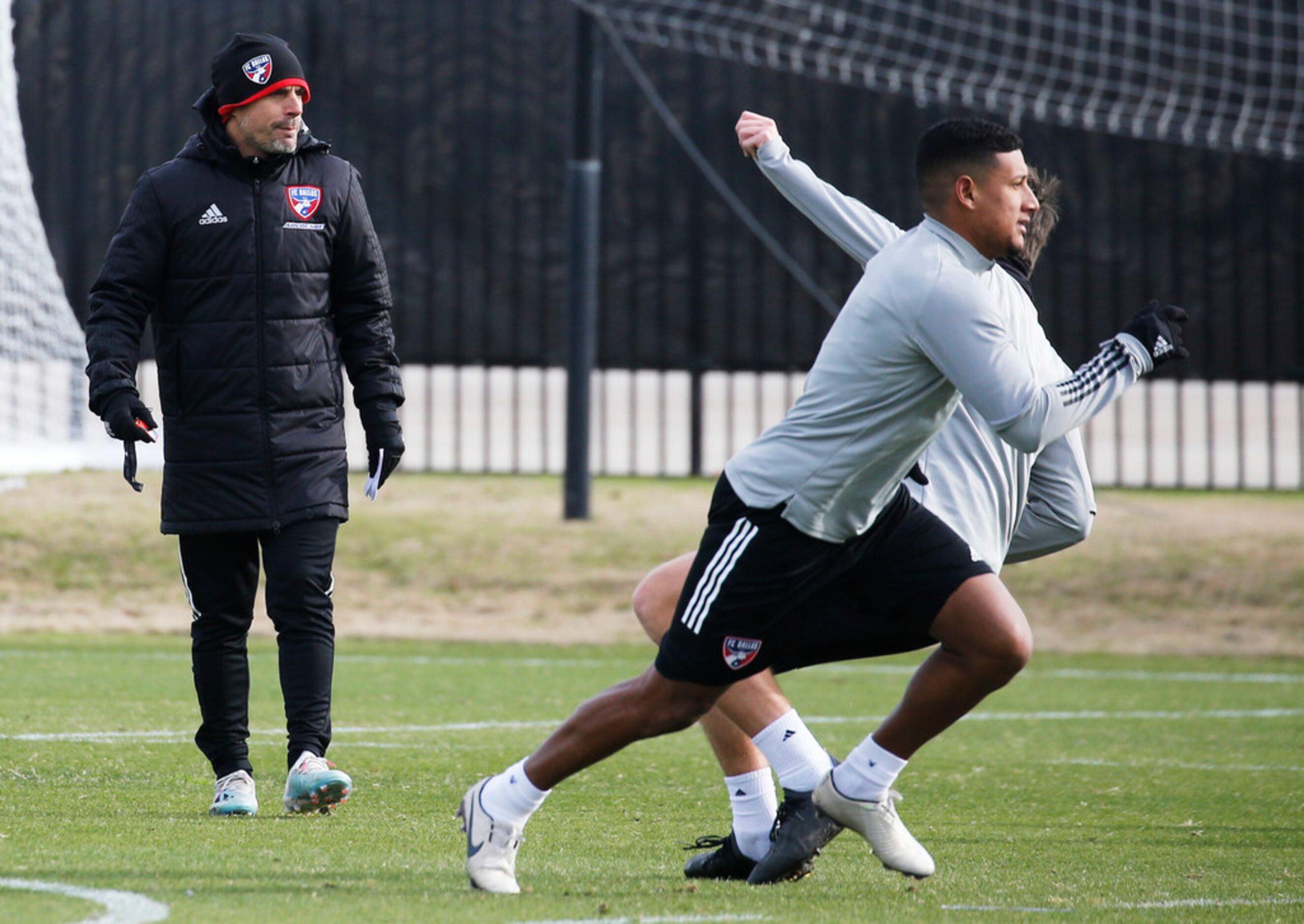 FC Dallas head coach Luchi Gonzalez watches players during the first practice of preseason...