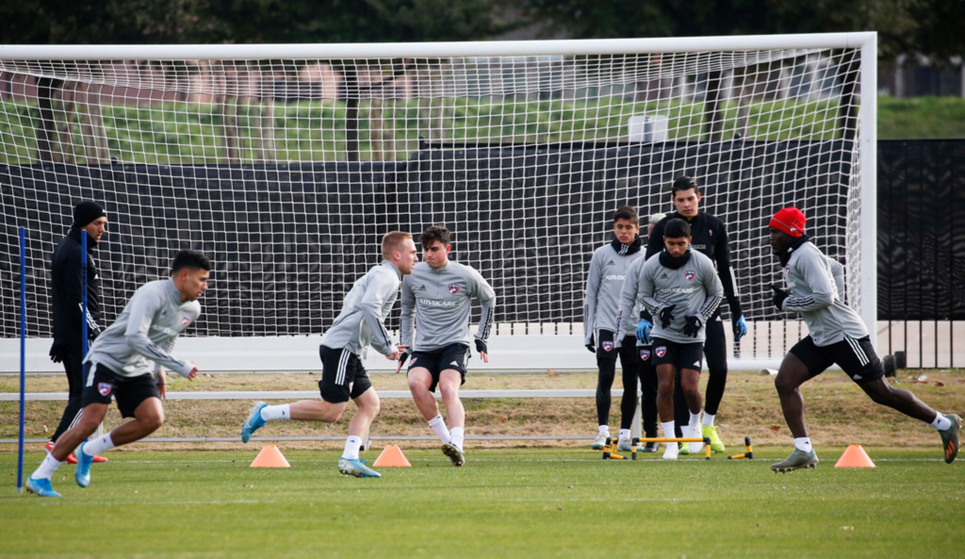 FC Dallas players run as they warm up for the first practice of preseason training at Toyota...