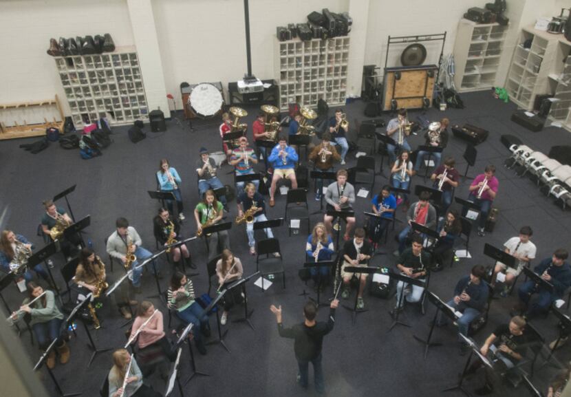 Reagan Brumley, director of instrumental music, leads a rehearsal for part of the high...
