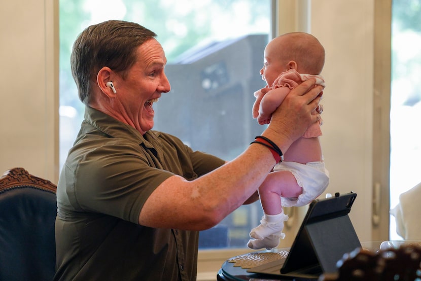 Dallas County Judge Clay Lewis Jenkins plays with his daughter, Grace, as he participates on...