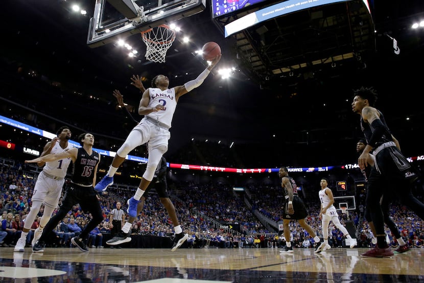 Kansas' Charlie Moore (2) shoots during the first half of the team's NCAA college basketball...