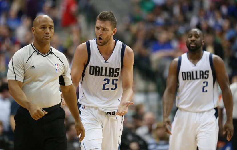 Dallas Mavericks forward Chandler Parsons (25) speaks to referee Marc Davis (8) in the...