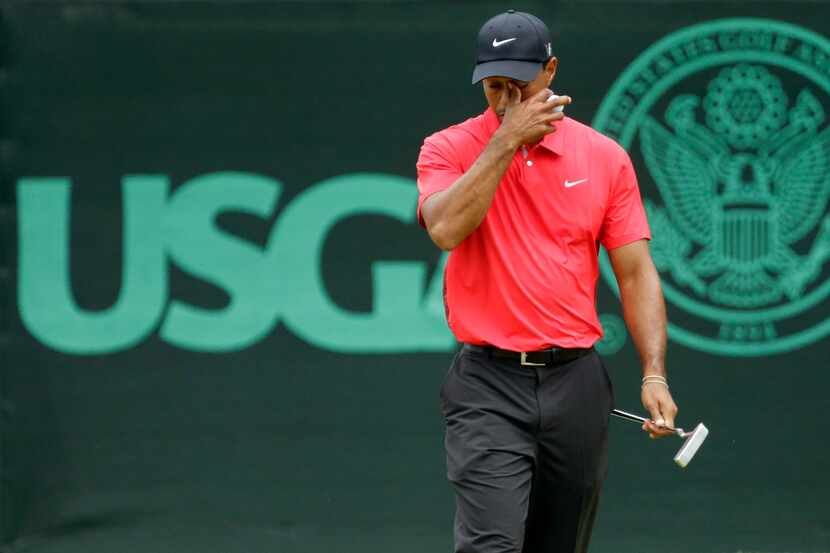 Tiger Woods reacts after putting on the eighth green during the fourth round of the U.S....