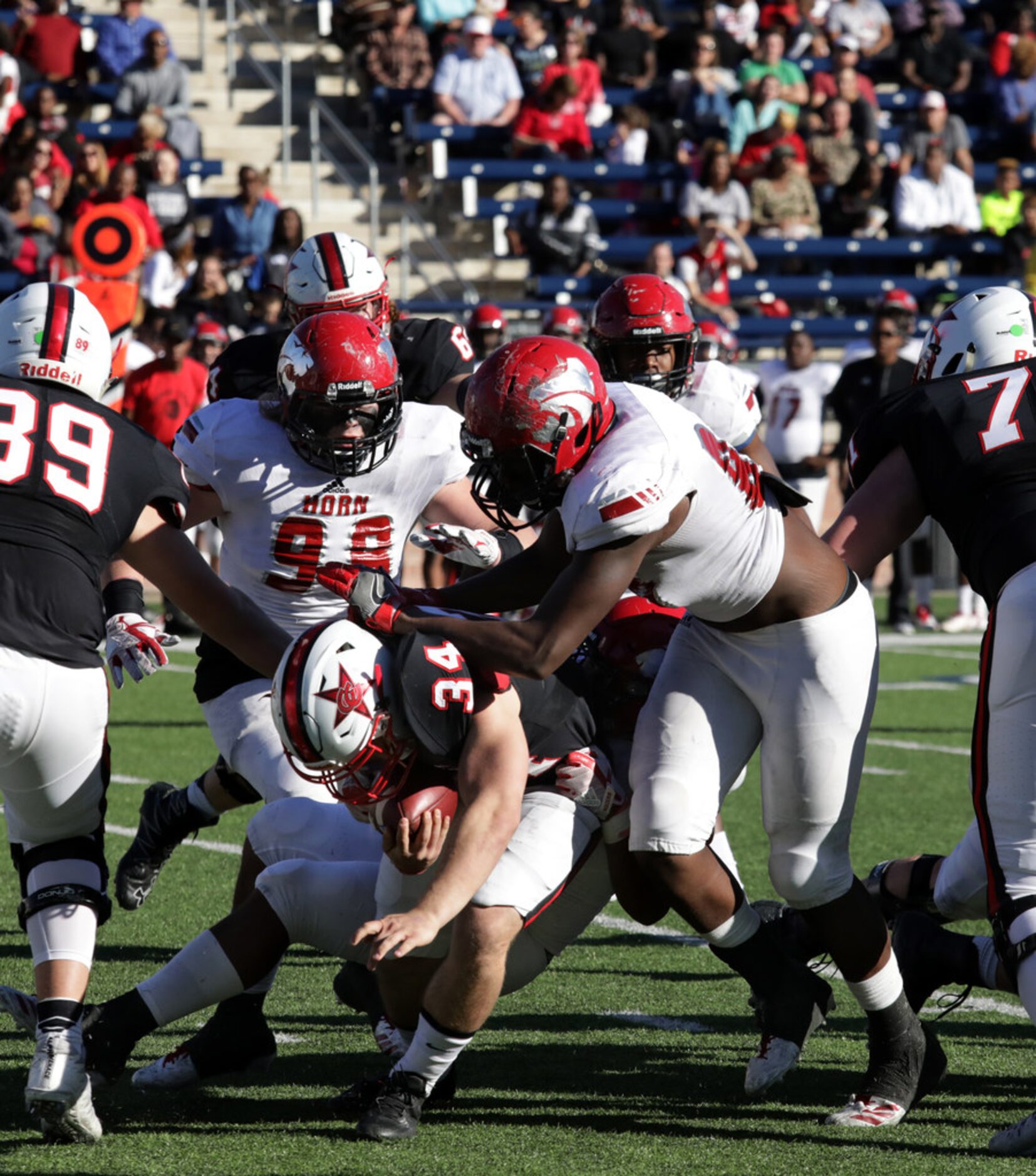 Coppell player 34, Ryan Hirt, breaks through the line during a Class 6A division I playoff...