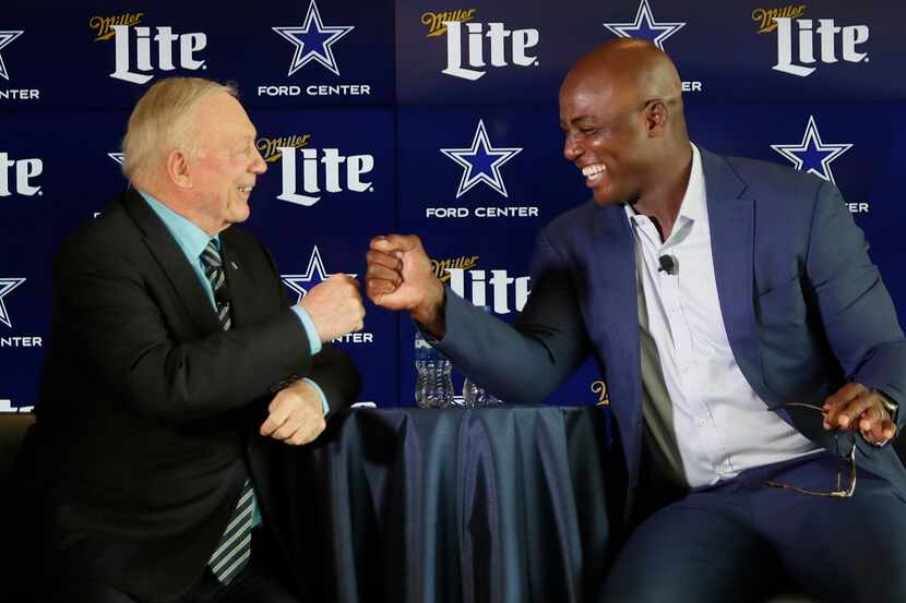 Cowboys owner Jerry Jones bumps fists with former player DeMarcus Ware (right) after Jones...