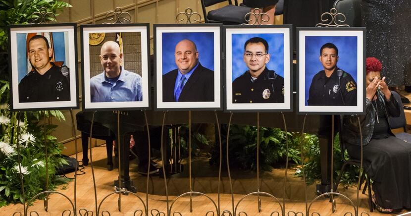 Photos of the fallen officers at a memorial service Tuesday in the Morton H. Meyerson...