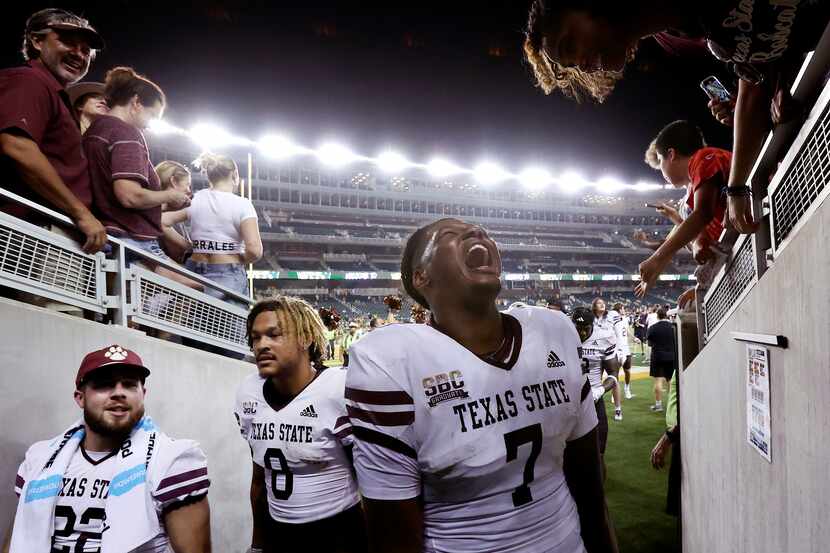 Texas State quarterback TJ Finley (7) celebrates as he enters the tunnel after defeating...