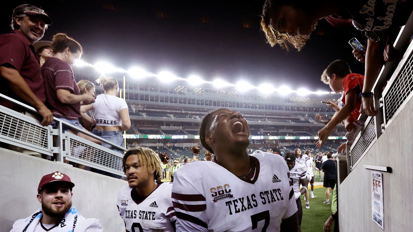 Texas State quarterback TJ Finley (7) celebrates as he enters the tunnel after defeating...