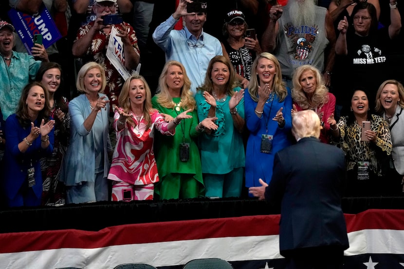 Republican presidential candidate Donald Trump acknowledges supporters as he departs a...