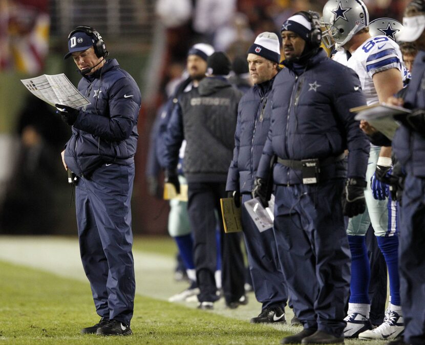 Dallas Cowboys head coach Jason Garrett makes a call in a game against the Washington...