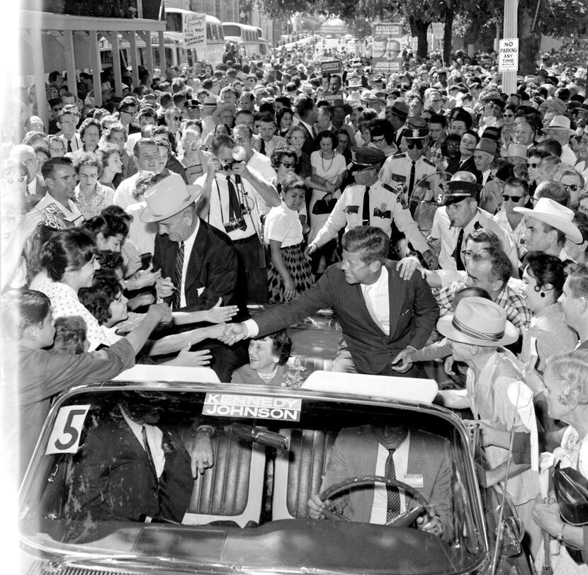 Judge Sarah T. Hughes sits between Lyndon Johnson and John F. Kennedy as their motorcade...