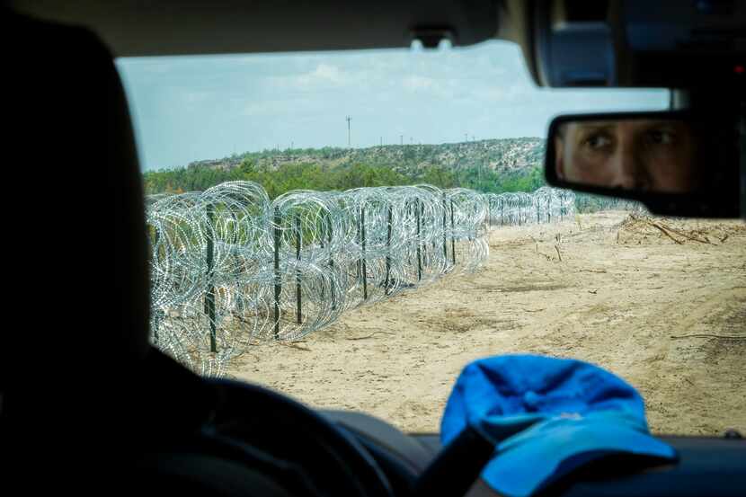 Poncho Nevárez drove along a stretch of concertina wire on his property along the Rio Grande...