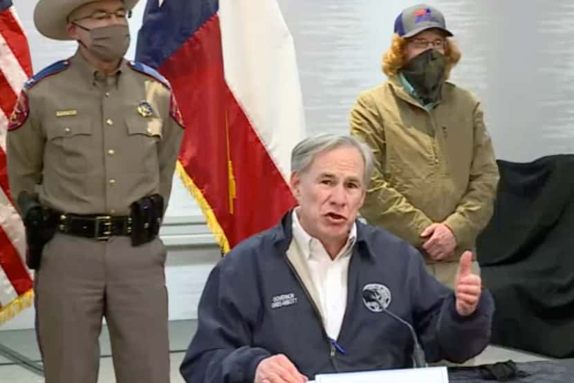 Gov. Greg Abbott, shown at a press conference Wednesday, has been defending fossil fuel use....