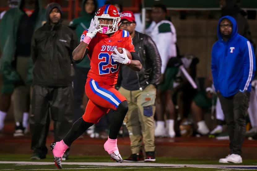 Duncanville running back Caden Durham (29) holds up four fingers as he races down the DeSoto...