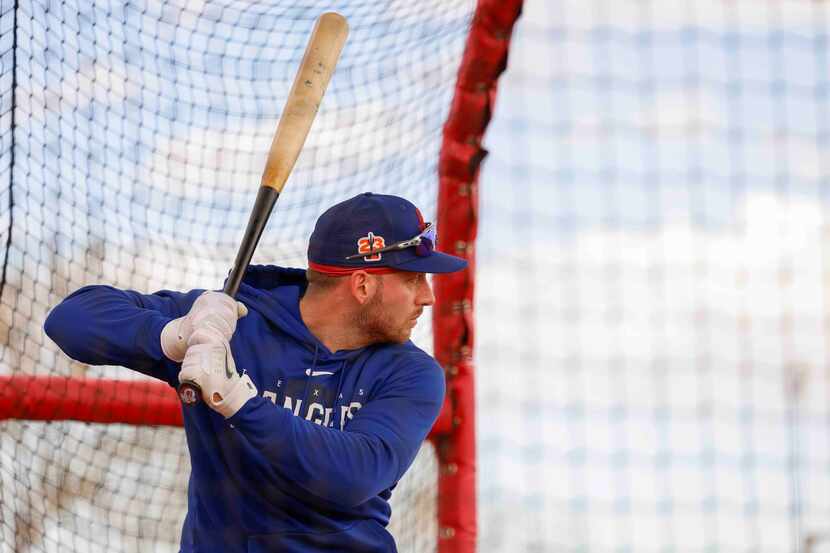 Texas Rangers catcher Mitch Garver waits for a pitch during batting practice in a spring...