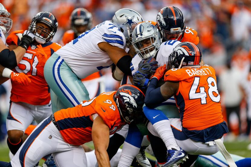 DENVER, CO - SEPTEMBER 17:  Running back Ezekiel Elliott #21 of the Dallas Cowboys is...