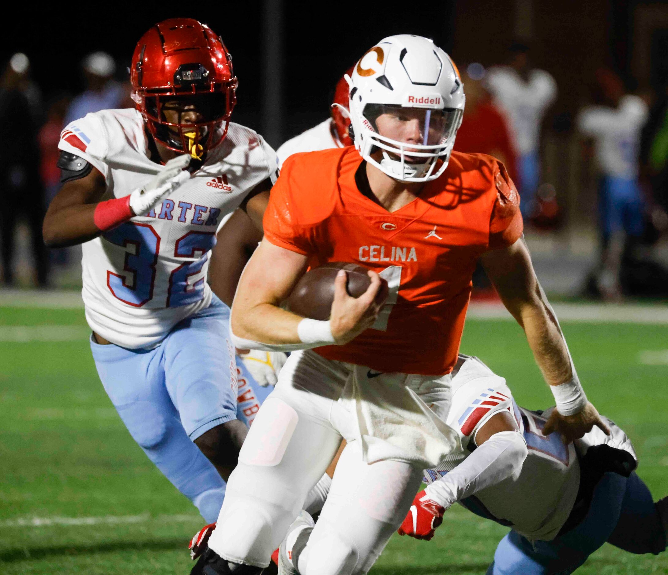 Celina High School’s Noah Bentley runs with the ball past  David W. Carter High School...